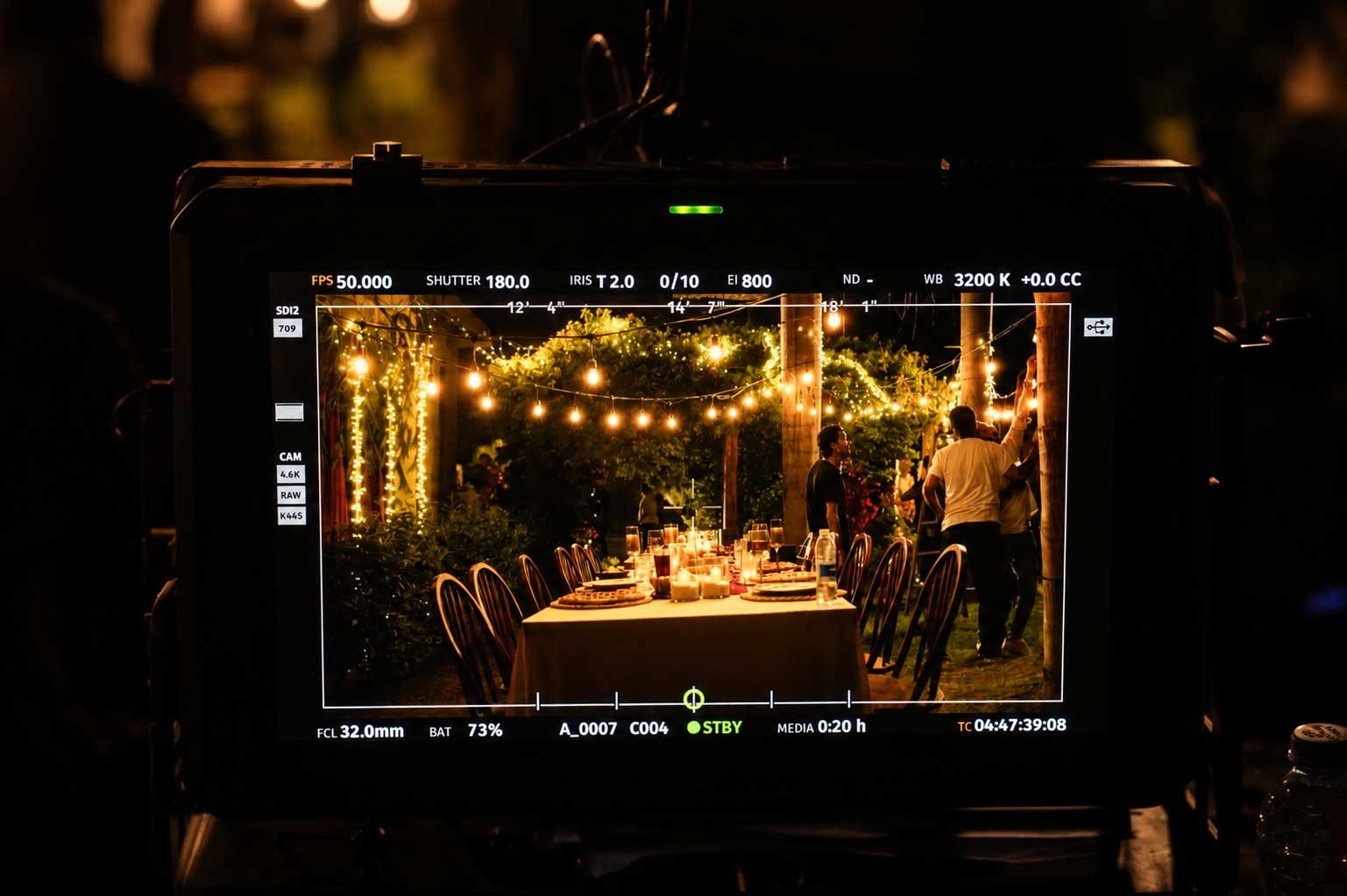 Camera monitor view of the Lahza dinner scene — Strike Media production